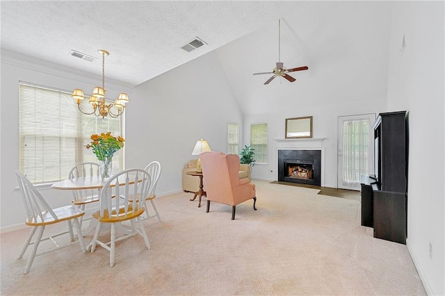 3040 Majestic Park Ct, Duluth, GA 30096 - carpeted dining area with baseboards, a chandelier, a premium fireplace, a ceiling fan, and high vaulted ceiling