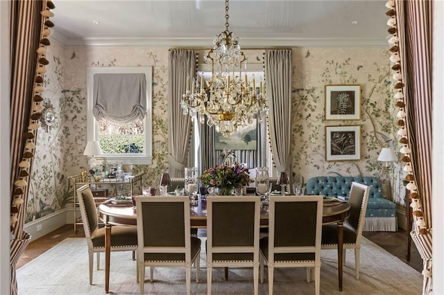 dining space with ornamental molding, hardwood / wood-style floors, and a notable chandelier