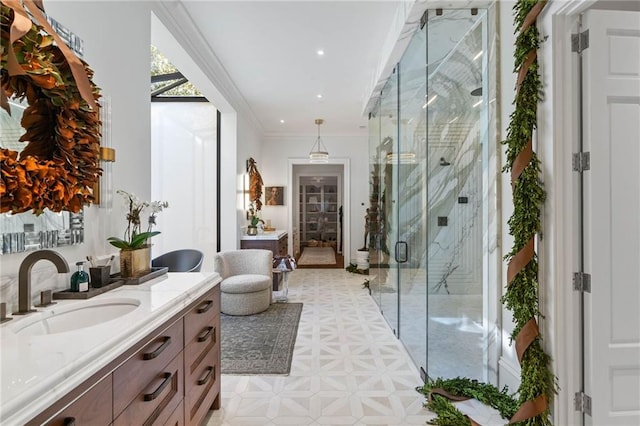 bathroom featuring a shower with door, vanity, and ornamental molding