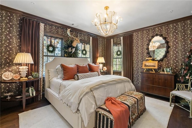 bedroom with crown molding and an inviting chandelier