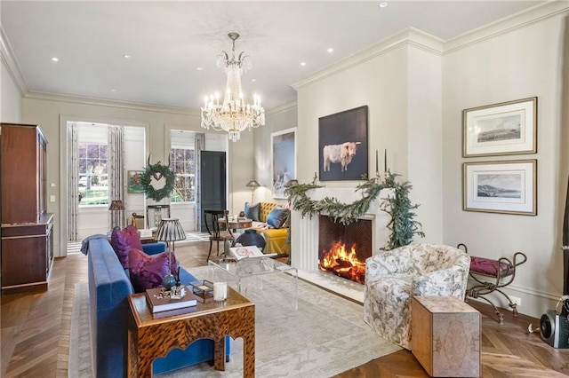 living room with an inviting chandelier, a high end fireplace, parquet flooring, and ornamental molding