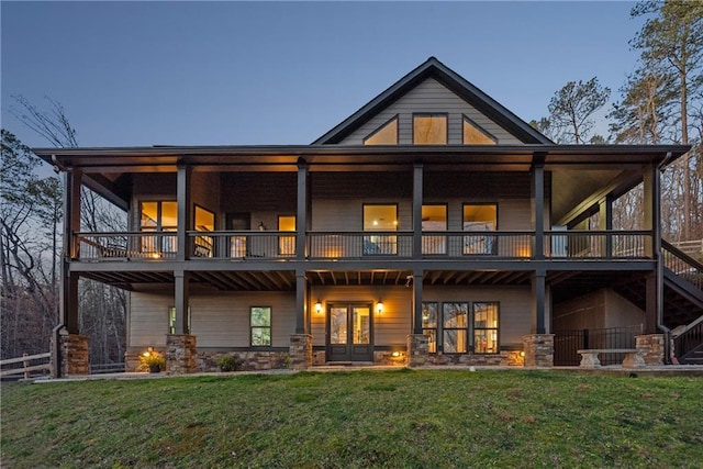 back of property with french doors and a yard