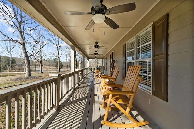 wooden terrace with covered porch and ceiling fan