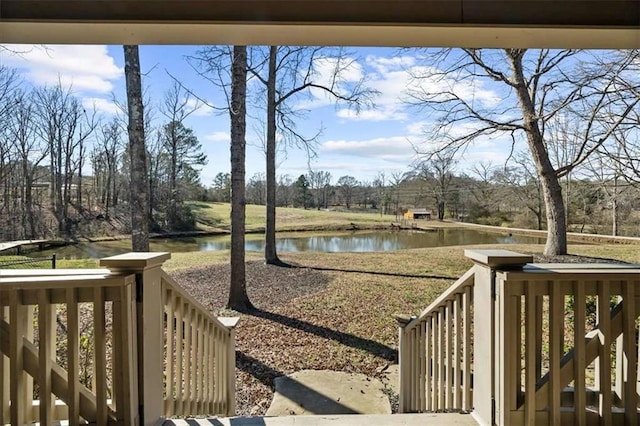 view of yard with a deck with water view