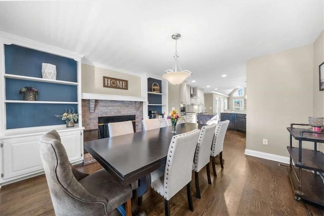 dining room with built in features, a brick fireplace, and dark hardwood / wood-style flooring