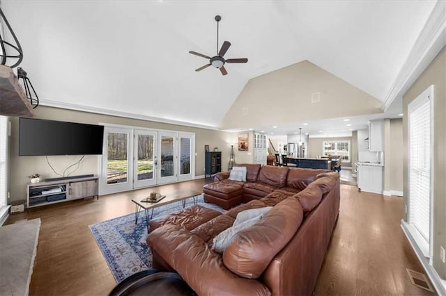 living room featuring ceiling fan, high vaulted ceiling, plenty of natural light, and dark hardwood / wood-style flooring