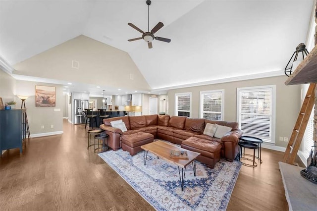 living room featuring ceiling fan, high vaulted ceiling, and wood-type flooring