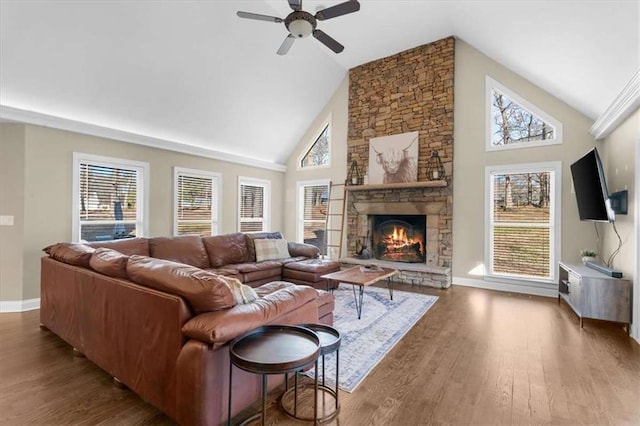 living room featuring high vaulted ceiling, ceiling fan, dark hardwood / wood-style floors, and a fireplace