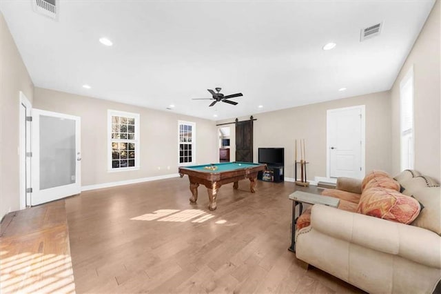 recreation room with billiards, ceiling fan, light hardwood / wood-style floors, and a barn door