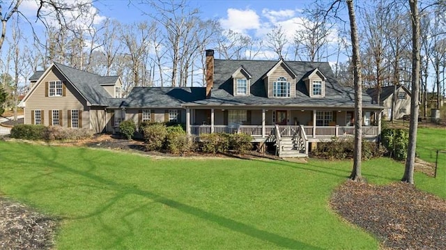 new england style home featuring covered porch and a front lawn