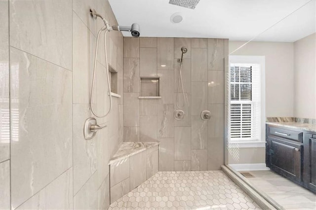 bathroom featuring vanity and tiled shower