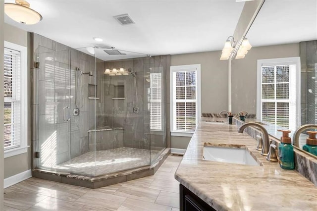 bathroom with vanity and a shower with shower door