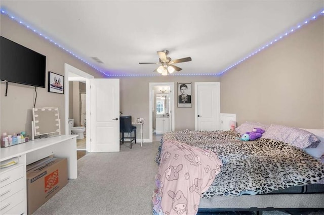 bedroom featuring ornamental molding, connected bathroom, and light colored carpet