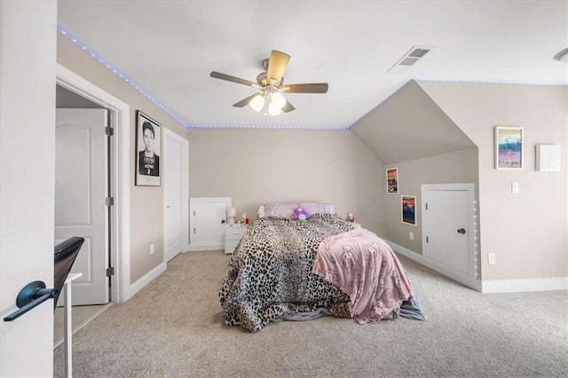 bedroom with light carpet, vaulted ceiling, and ceiling fan