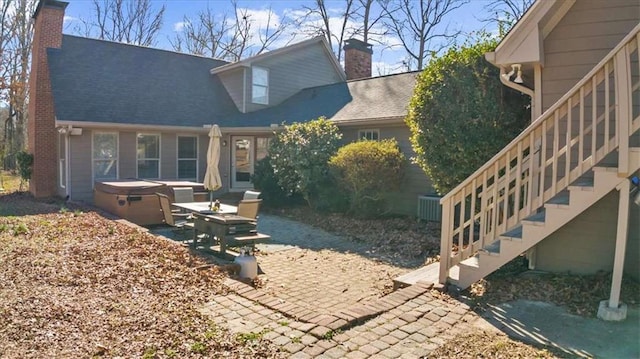 exterior space featuring a patio area and a hot tub