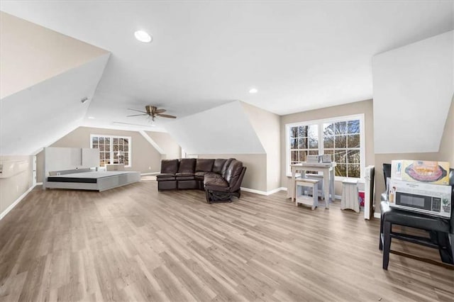 interior space featuring lofted ceiling, ceiling fan, light hardwood / wood-style floors, and a healthy amount of sunlight