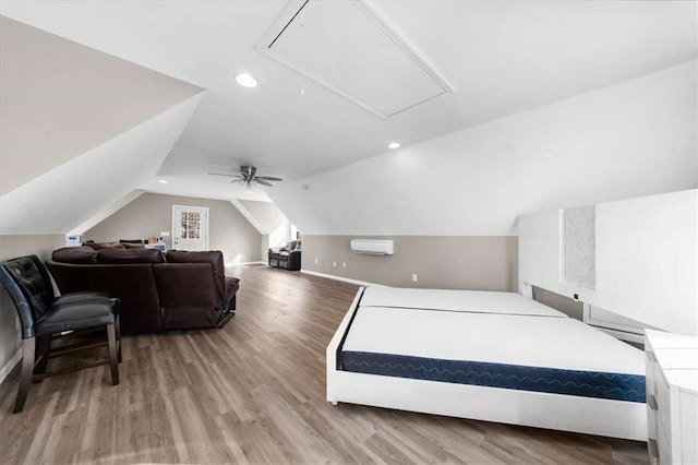 bedroom featuring hardwood / wood-style flooring, ceiling fan, a wall mounted AC, and lofted ceiling