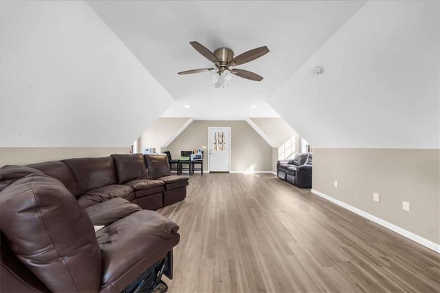 living room featuring ceiling fan, wood-type flooring, and lofted ceiling