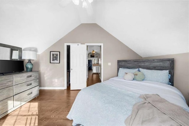 bedroom with ceiling fan, vaulted ceiling, and dark hardwood / wood-style flooring