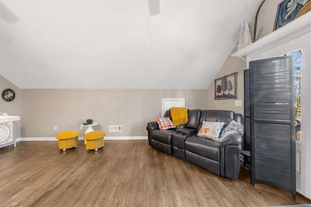 living room with vaulted ceiling and wood-type flooring