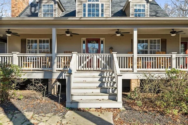 view of exterior entry with ceiling fan and a porch