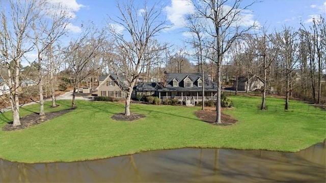 view of property's community featuring a yard and a water view