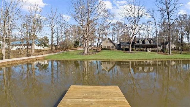 view of dock featuring a yard and a water view