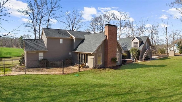 rear view of house with a lawn