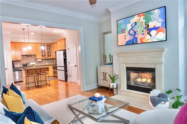 living room featuring crown molding and light wood-type flooring