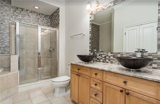 bathroom featuring an enclosed shower, tasteful backsplash, ornamental molding, vanity, and tile patterned flooring