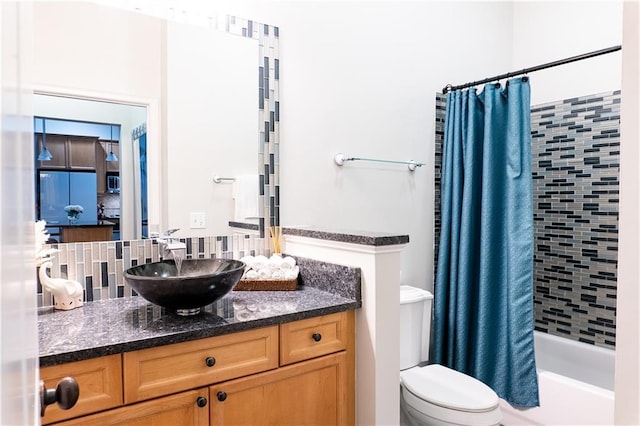 full bathroom featuring tasteful backsplash, vanity, toilet, and shower / tub combo