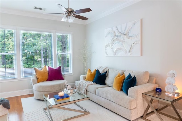 living room with hardwood / wood-style floors, crown molding, plenty of natural light, and ceiling fan