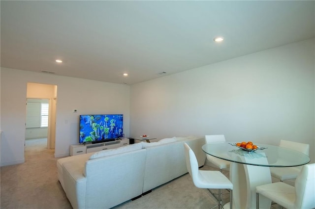 living area with carpet, visible vents, baseboards, and recessed lighting