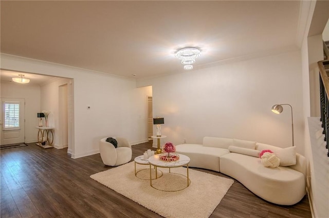 living area featuring dark wood-type flooring, ornamental molding, and baseboards