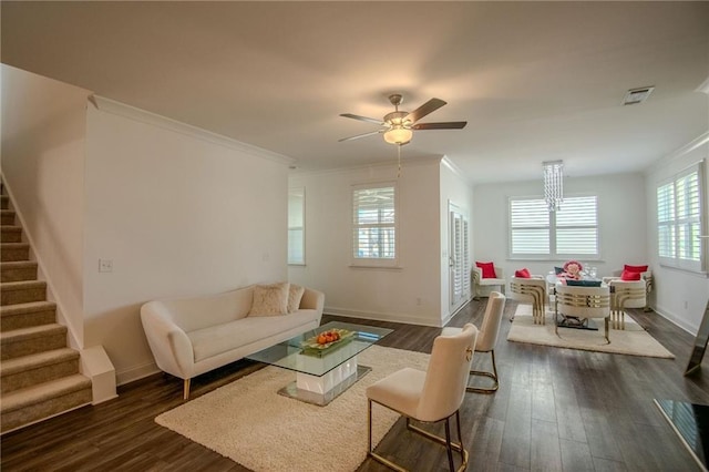 living room with dark wood-style floors, visible vents, ornamental molding, and stairway