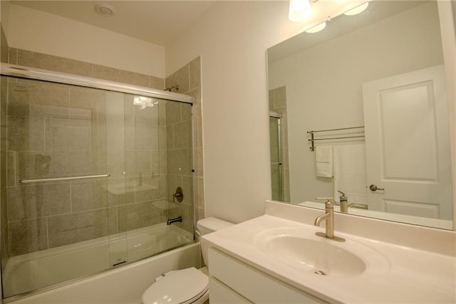 full bathroom featuring bath / shower combo with glass door, vanity, and toilet