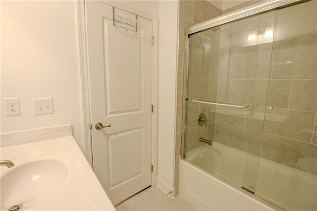 full bathroom with tile patterned flooring, combined bath / shower with glass door, and a sink