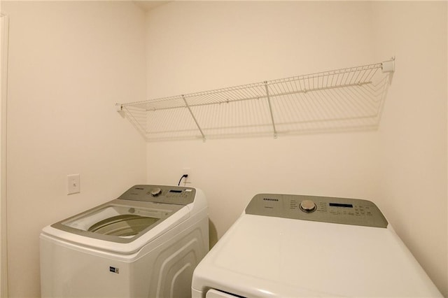 washroom featuring laundry area and separate washer and dryer