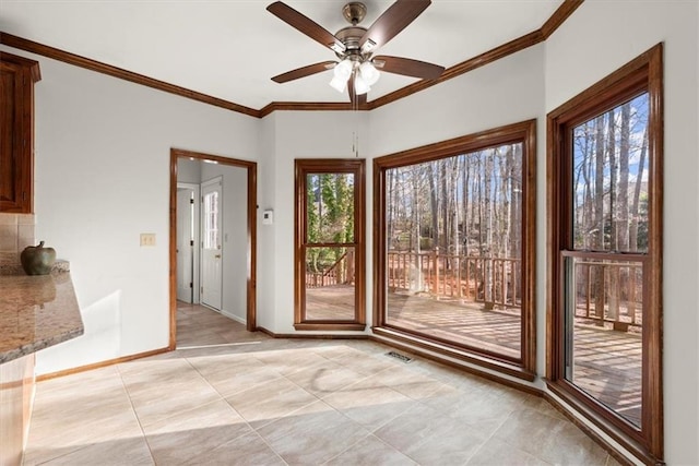 doorway featuring light tile patterned flooring, ceiling fan, and crown molding