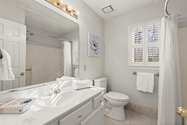 bathroom featuring toilet, vanity, tile patterned flooring, and a shower with shower curtain