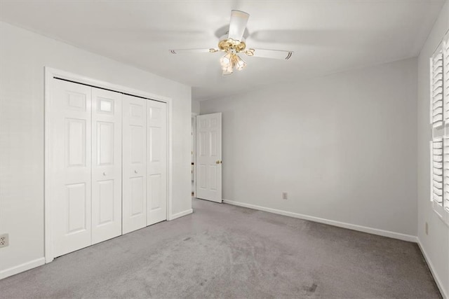 unfurnished bedroom with light carpet, multiple windows, a closet, and ceiling fan