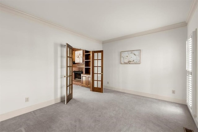 carpeted empty room with french doors and ornamental molding