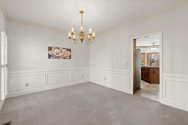 spare room with light carpet, a chandelier, and crown molding