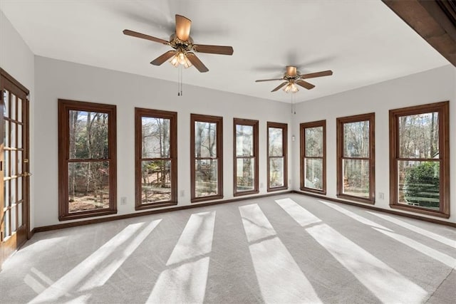 unfurnished sunroom featuring a wealth of natural light and ceiling fan