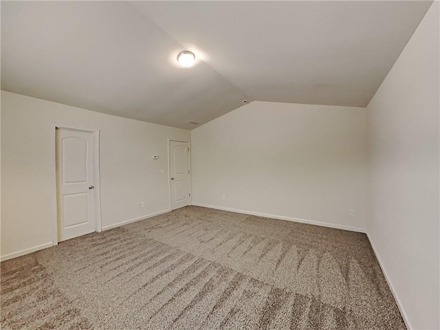 bonus room with lofted ceiling and carpet