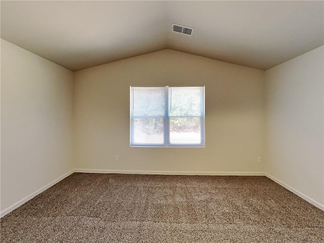 carpeted spare room with lofted ceiling