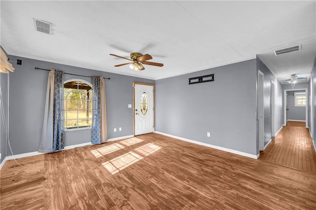 spare room with ceiling fan, wood-type flooring, and plenty of natural light