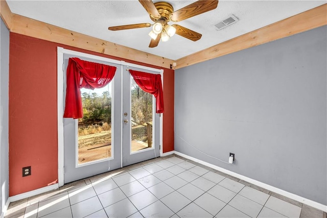 entryway featuring light tile patterned floors, ceiling fan, and french doors