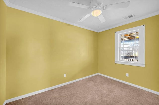 spare room with ornamental molding, carpet, and ceiling fan