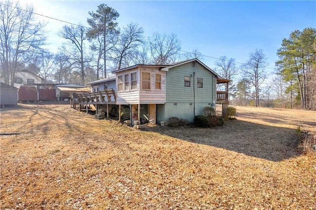 rear view of house with a sunroom and a deck